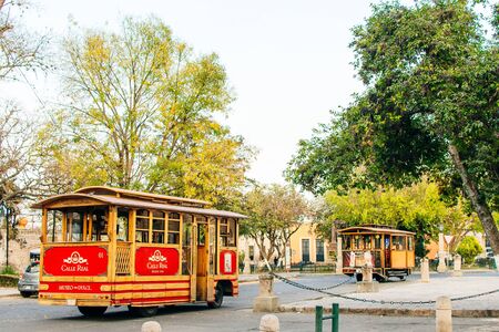 Morelia, colombia - june,, 2018 - Old red tram on wheels in town on the pavement.のeditorial素材