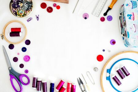 Flat lay composition with scissors and sewing supplies on white background. Space for text.