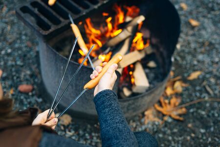 Bonfire sausages on a bonfire with a grill in the backgroundの写真素材
