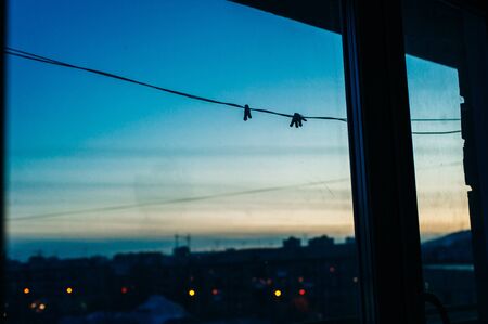 Dawn on the balcony. clothespins on a rope.の写真素材