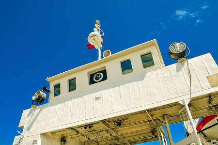 A detail part of a big sea ferry, the captain bridge during the hot summer day