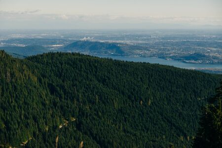 Aerial View of Grouse Mountain with Downtown city. North Vancouver, BC, Canadaの写真素材
