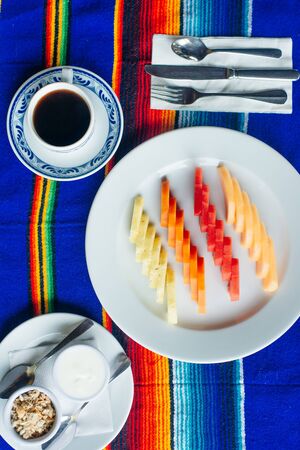 slices of fruit beautifully sliced on a white plate in a restaurant. Mexican food.の写真素材