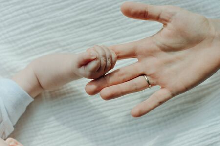 Newborn children's hand in mother hand. Mom and her Child.