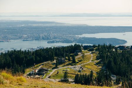 Aerial View of Grouse Mountain with Downtown city. North Vancouver, BC, Canada
