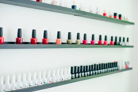 usa, la - january, 2020 colorful nail polish colors in a row at nails saloon on white background.のeditorial素材