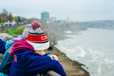 Canadian side of Niagara Falls in autumn. ship with tourists.