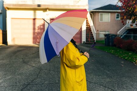 girl under a multi-colored umbrella. bright picture.