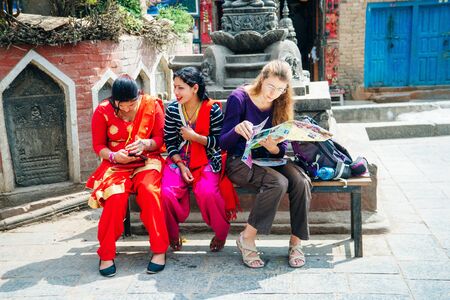 girls are sitting Swayambhunath in Kathmandu, Nepal - december, 2019.のeditorial素材