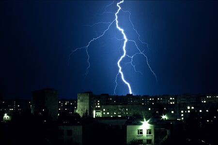 Thunderbolt and Lightning.night thunderstorm over the buildings in the city.