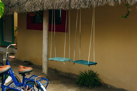 A rental bicycles stand in a row on a parking in hotel.