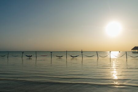 Relaxing in a hammock over the water, Isla Holbox, Mexico.