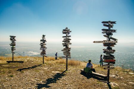 Pyatigorsk, Russia â may 2019 Pointers on the top of mountain. Wooden signs of direction with cities name .のeditorial素材