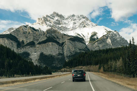 Scenic road through the Canadian Rockies, surrounded with rocky mountains. Taken in Banff National...