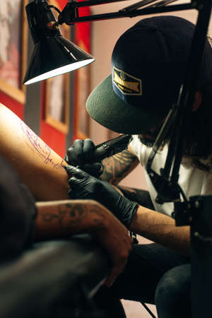 Tattoo artist workplace with machine and bottles with black tattoo ink.のeditorial素材
