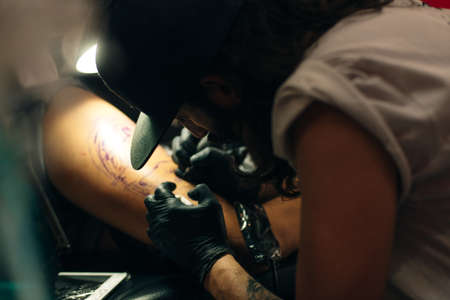 Tattoo artist workplace with machine and bottles with black tattoo ink.のeditorial素材