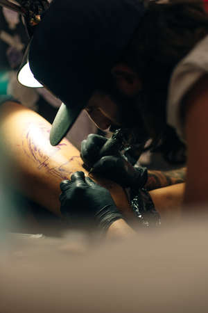 Tattoo artist workplace with machine and bottles with black tattoo ink.のeditorial素材