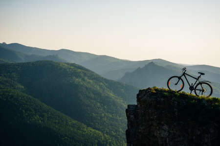 A trip by bike in mountain on the sunset. russia - sep, 2019.