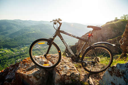 A trip by bike in mountain on the sunset. russia - sep, 2019.のeditorial素材