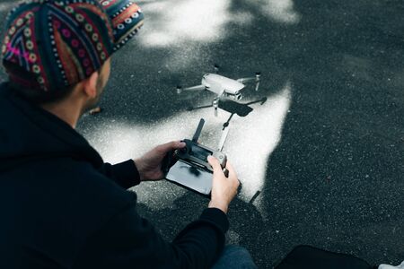 Drone remote control. Remote control in hand man. Man holds remote controller with his hands and...