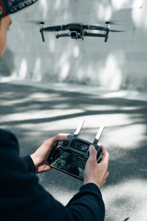 Drone remote control. Remote control in hand man. Man holds remote controller with his hands and...