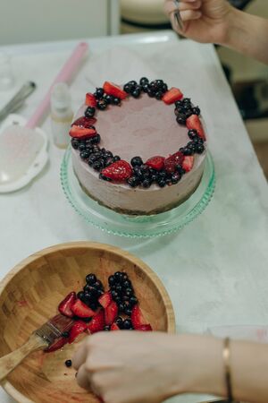 homemade raw strawberry cakes with fresh berries.