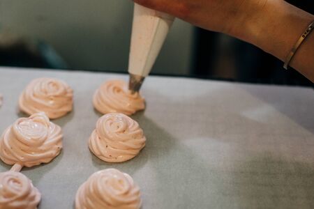 Homemade pink marshmallows on baking paper background on the kitchenの写真素材