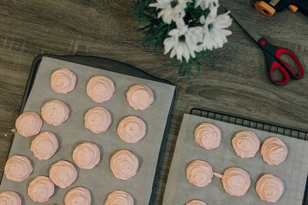 Homemade pink marshmallows on baking paper background on the kitchen.の写真素材