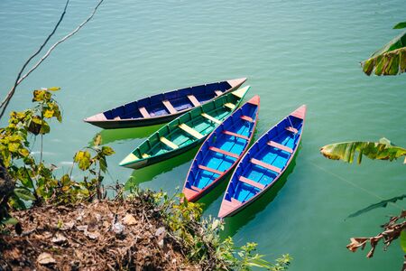 Phewa Lake with multicoloured boats in the valley of Pokhara in central Nepalの写真素材