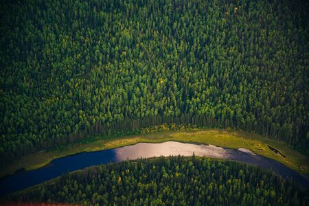 view from a height of taiga with a river in siveriaの写真素材