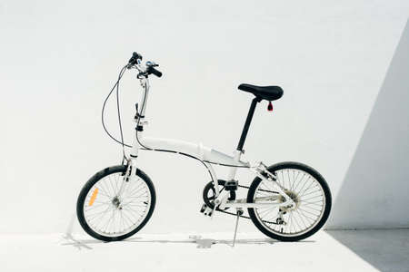 white folding bike on a white background.の写真素材