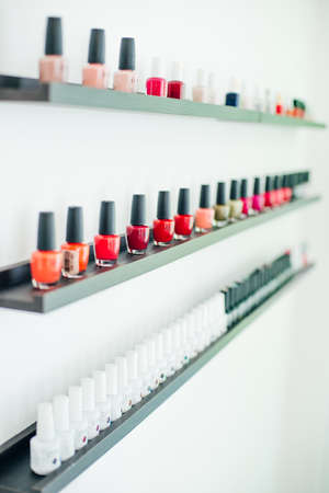 usa, la - january, 2020 colorful nail polish colors in a row at nails saloon on white background.のeditorial素材