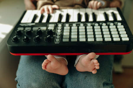 baby feet and piano. musical baby concept.の写真素材