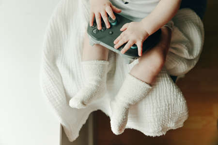 a very small child plays with the joystick.の写真素材