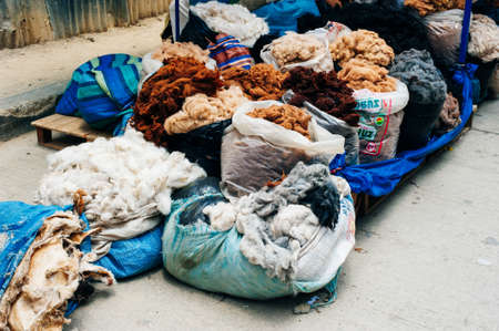 colorful lamas wool in sacks at the marketのeditorial素材
