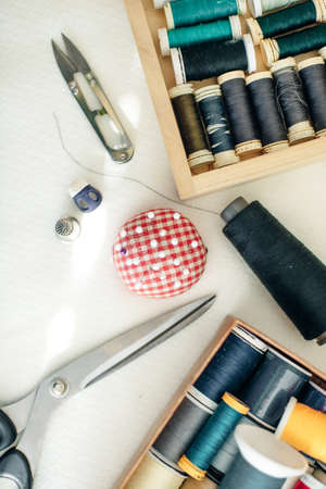 Flat lay composition with scissors and sewing supplies on white backgroundの写真素材