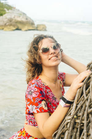 blonde in a bright dress on the background of the oceanの写真素材