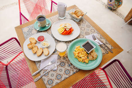 breakfast for two in the hotel with eggs, toast and fruitの写真素材