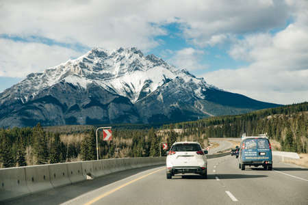 Scenic road through the Canadian Rockies, surrounded with rocky mountains. Taken in Banff National Park, Alberta, Canad.のeditorial素材