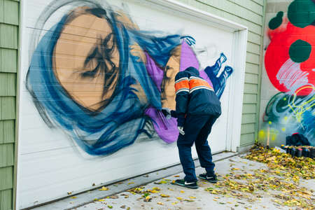 canada, toronto - december, 2019 Graffiti artist spraying the wall.のeditorial素材