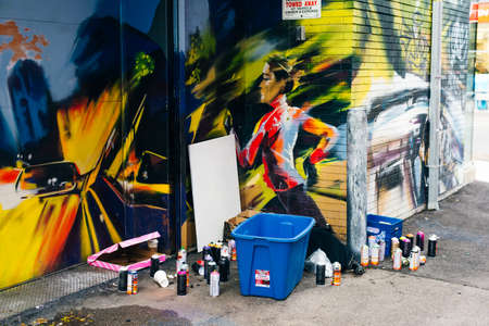 canada, toronto - december, 2019 Graffiti artist spraying the wall.のeditorial素材