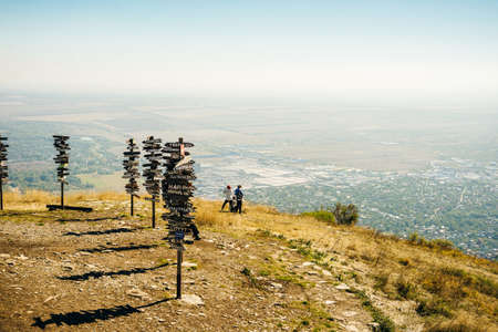 Pyatigorsk, Russia â may 2019 Pointers on the top of mountain. Wooden signs of direction with cities name .のeditorial素材