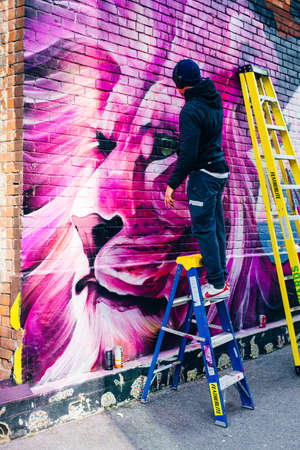 canada, toronto - december, 2019 Graffiti artist spraying the wallのeditorial素材