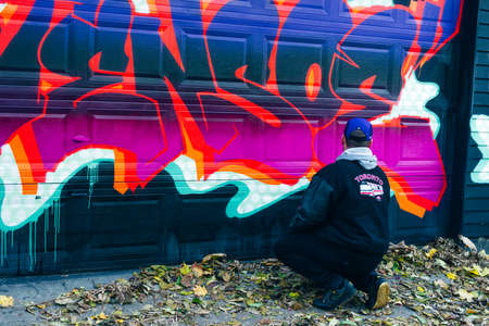 canada, toronto - december, 2019 Graffiti artist spraying the wallのeditorial素材