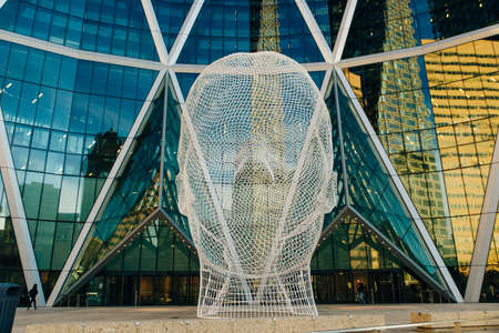Calgary, Alberta, Canada - August 2019 Wonderland sculpture by famous artist Jaume Plensa in front of The Bow tower.のeditorial素材