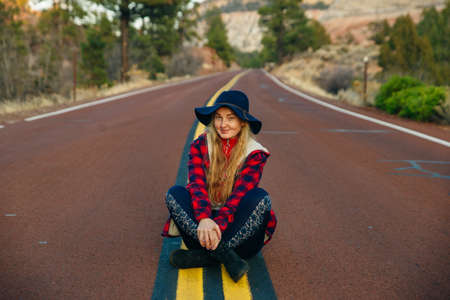 girl sitting on the road in Zion National Park in southwestern Utah near the town of Springdale.の写真素材