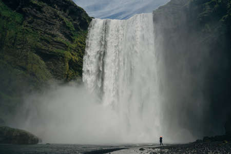 The Skogarfoss waterfall in southern Iceland with tourists. High quality photo