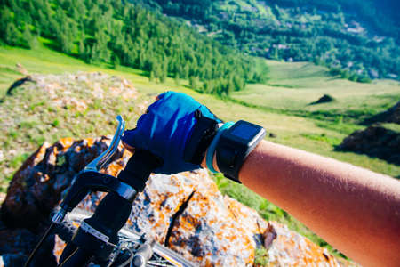 Close-up of a cyclist's hand in a glove holding a bicycle handlebar. High quality photoの写真素材