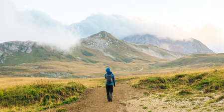 Drinking tea on green hills. Water running down, small river. Nature travel russiaの写真素材