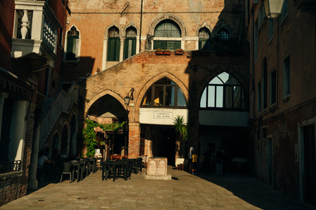 View of old narrow street in Venice, Italy. Architecture and landmark of Italy. Cozy cityscape of Rome. High quality photoのeditorial素材